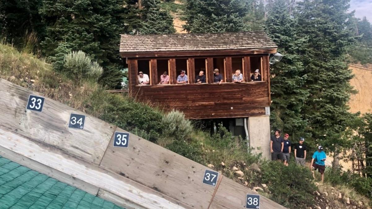 Norwegian Coaching Staff. on the outside of the 60 meter hill, wearing dark shirts, at the Utah Olympic Park during the 2022 Springer Tournee.