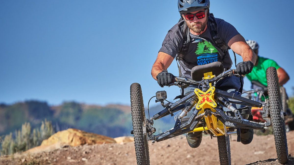 Adaptive Rider using a hand bike at MOFO Camp in 2022.