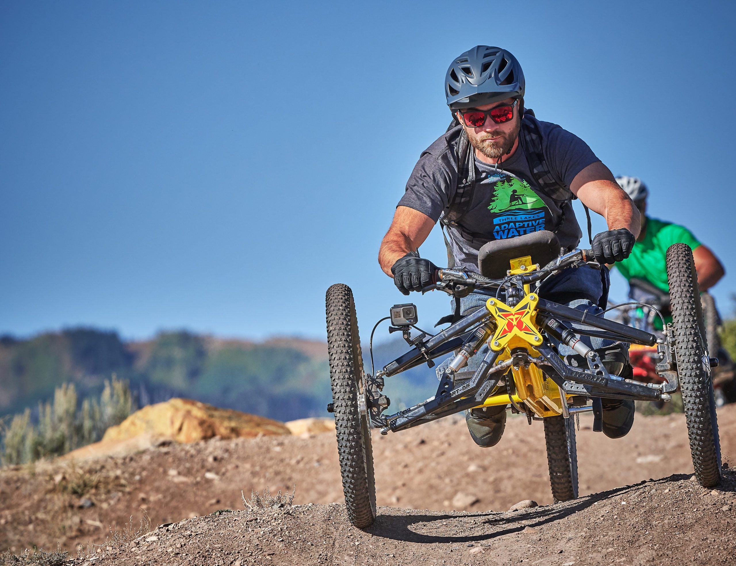 Adaptive Rider using a hand bike at MOFO Camp in 2022.
