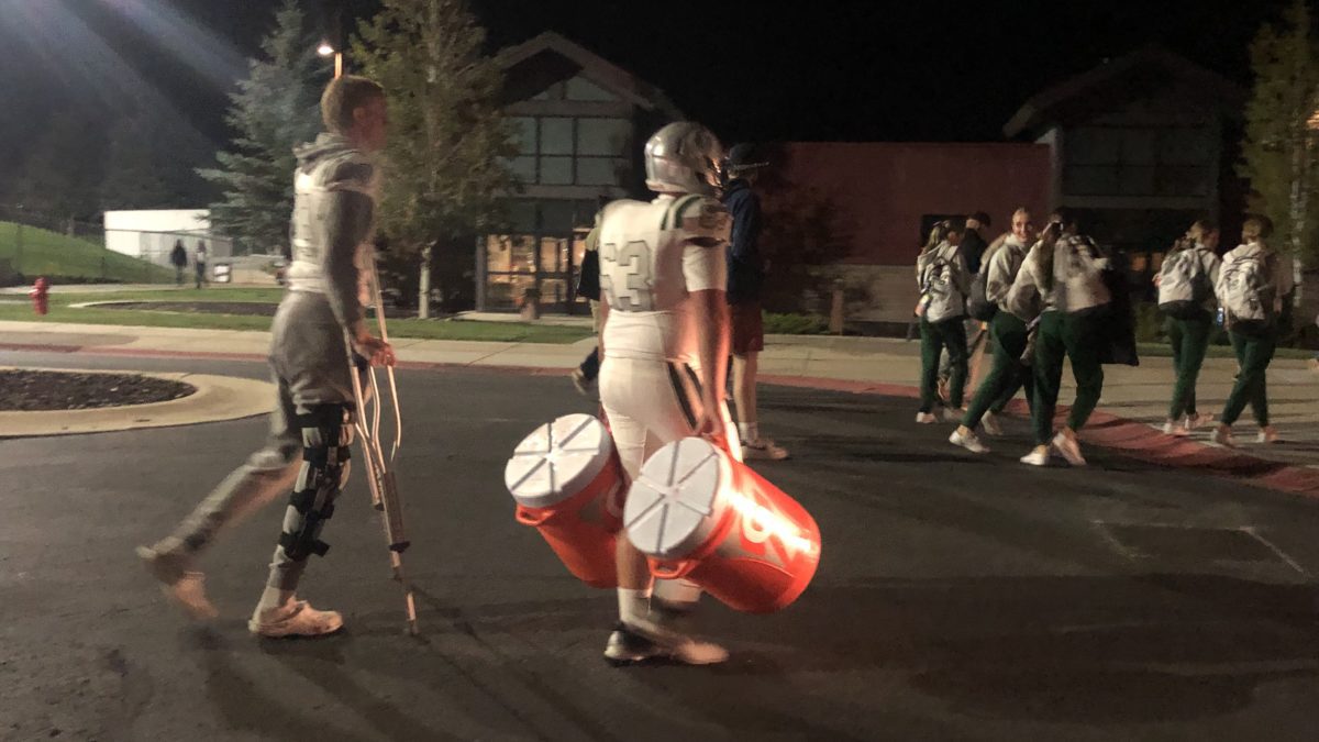 Olympus High School cheerleaders, football player and benched athlete walking back to their Team Bus to drive to Salt Lake City after a defeat by Park City High.