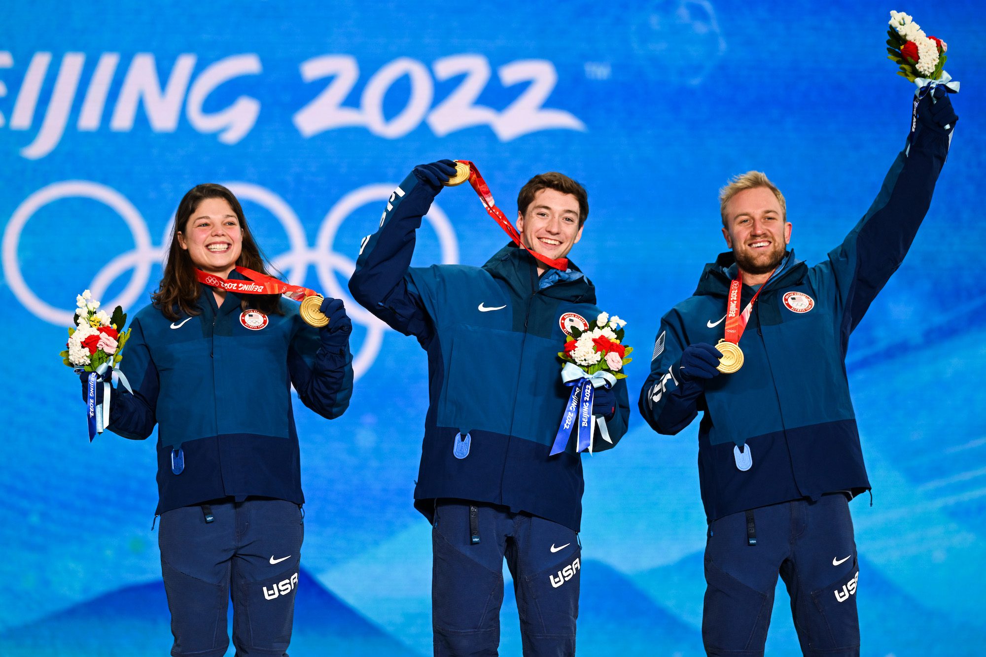 (L - R) Gold medallists Ashley Caldwell, Christopher Lillis and Justin Schoenefeld of Team United States celebrate during the Freestyle Skiing Mixed Team Aerials medal ceremony on Day 7 of the Beijing 2022 Winter Olympic Games at Zhangjiakou Medal Plaza on February 11, 2022 in Zhangjiakou, Hebei Province of China.