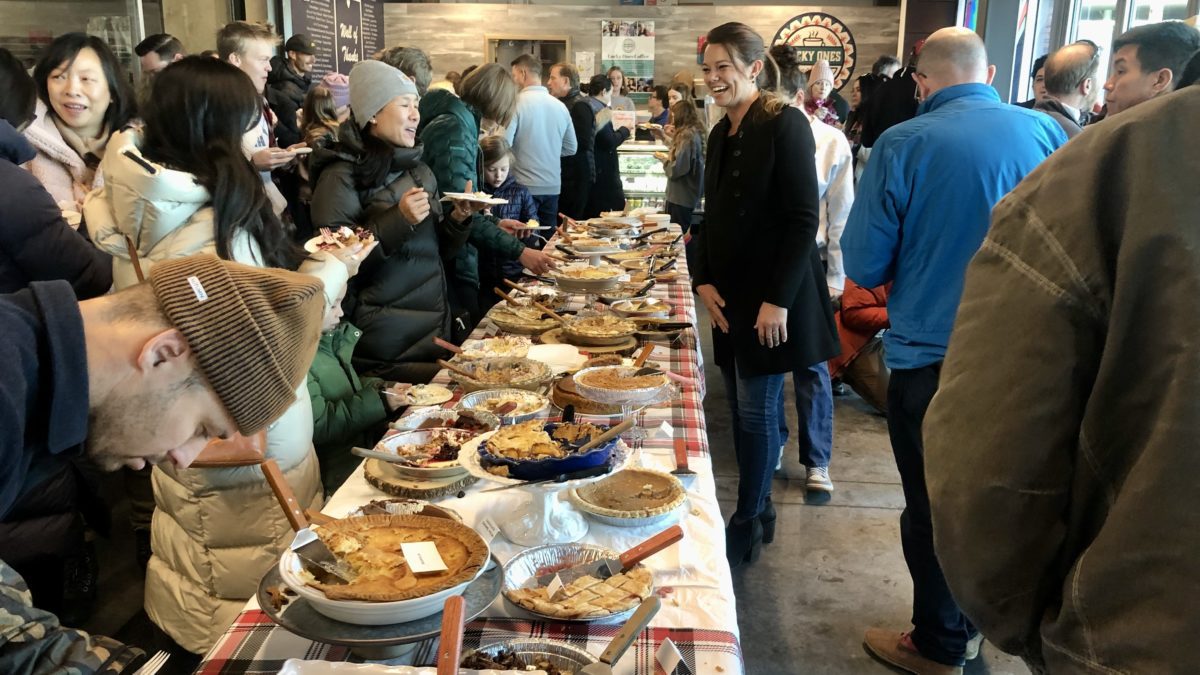 Casey Marsh laughing with some of her fellow organizers and guests at Pie Breakfast on Thanksgiving at Lucky Ones Coffee Shop.