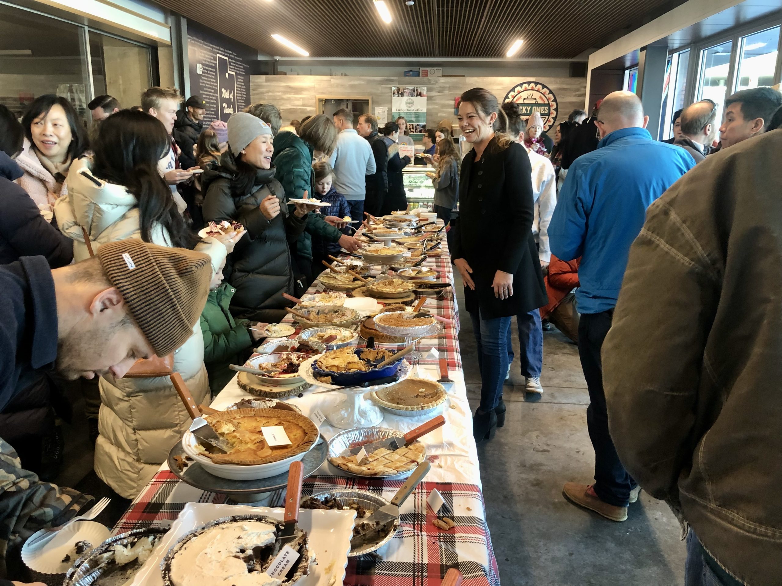 Casey Marsh laughing with some of her fellow organizers and guests at Pie Breakfast on Thanksgiving at Lucky Ones Coffee Shop.