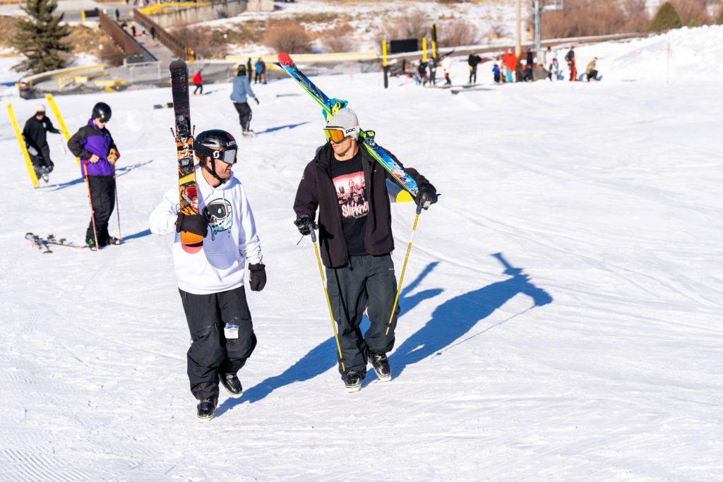 Robin Gillon and fellow pro skier Nick Geopper walking to the top of the terrain park at Woodward