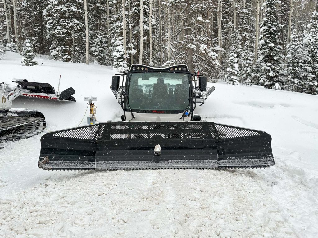 Snowcat parked with its engine block heater plugged in prior to heading out.