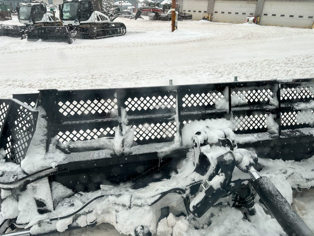 Back of the front plow showing all the complex pieces that make it function.