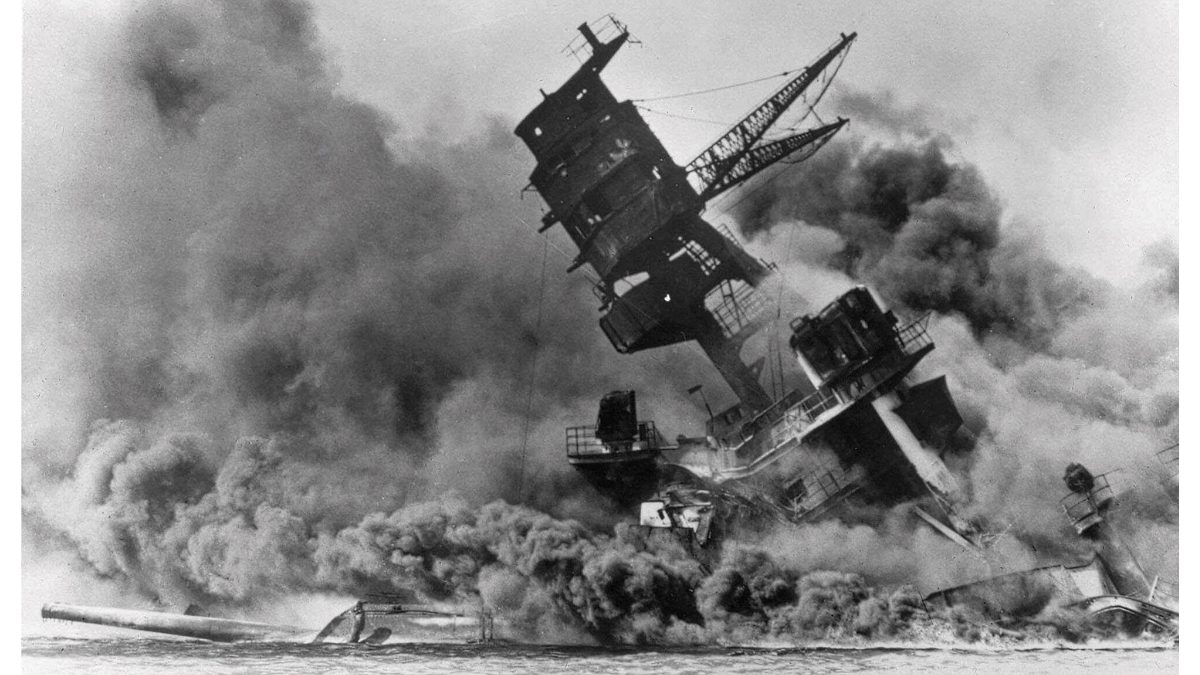 In this photo provided by the U.S. Navy, smoke rises from the battleship USS Arizona as it sinks during the Japanese attack on Pearl Harbor, Hawaii, Dec. 7, 1941. The U.S. Navy and the National Park Service will host a remembrance ceremony at Pearl Harbor in December 2022, the 81st anniversary of the 1941 Japanese bombing. (AP Photo/File)