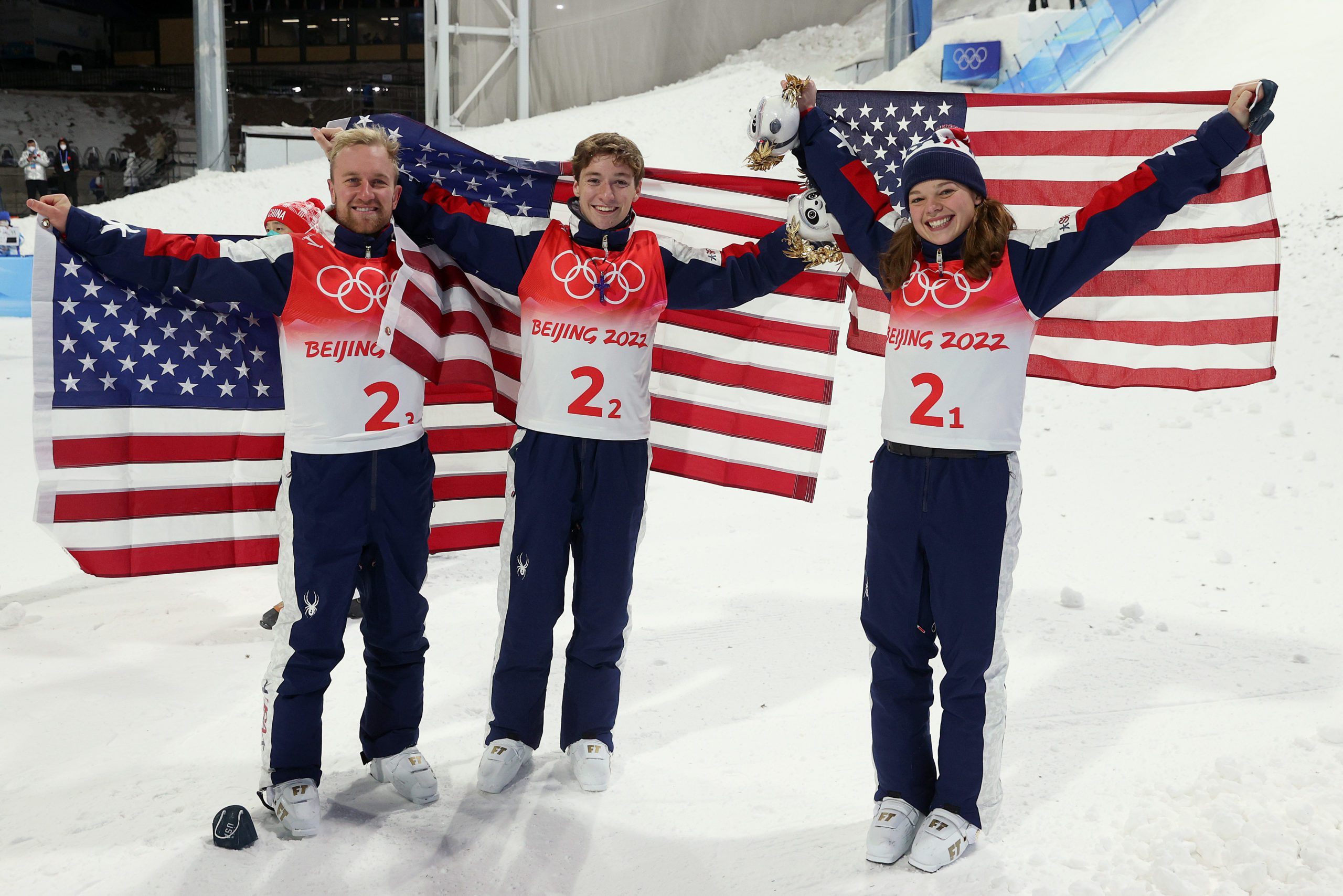 ZHANGJIAKOU, CHINA - FEBRUARY 10: (L-R) Gold medallists Justin Schoenefeld, Christopher Lillis and Ashley Caldwell of Team United States pose during the Freestyle Skiing Mixed Team Aerials flower ceremony on Day 6 of the Beijing 2022 Winter Olympics at Genting Snow Park on February 10, 2022 in Zhangjiakou, China.