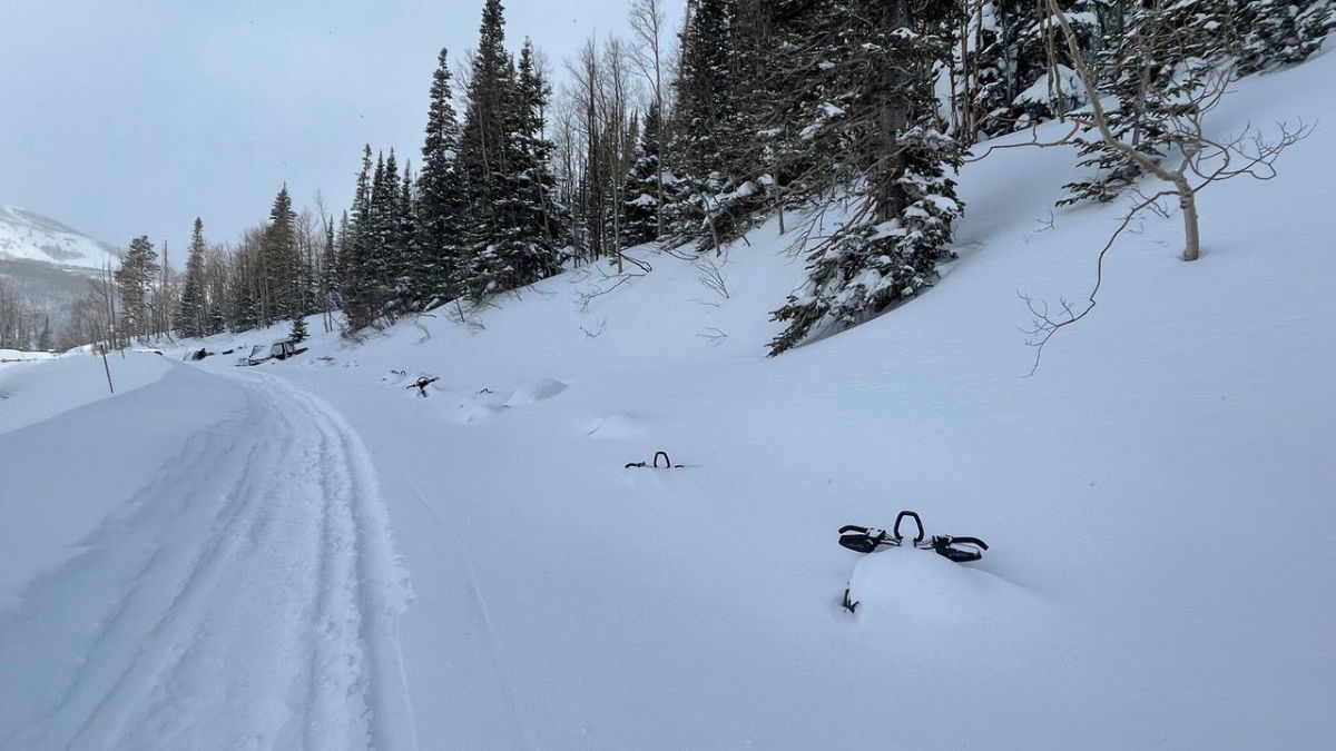 Snowmobiles parked above the seasonal gate in Empire Pass.