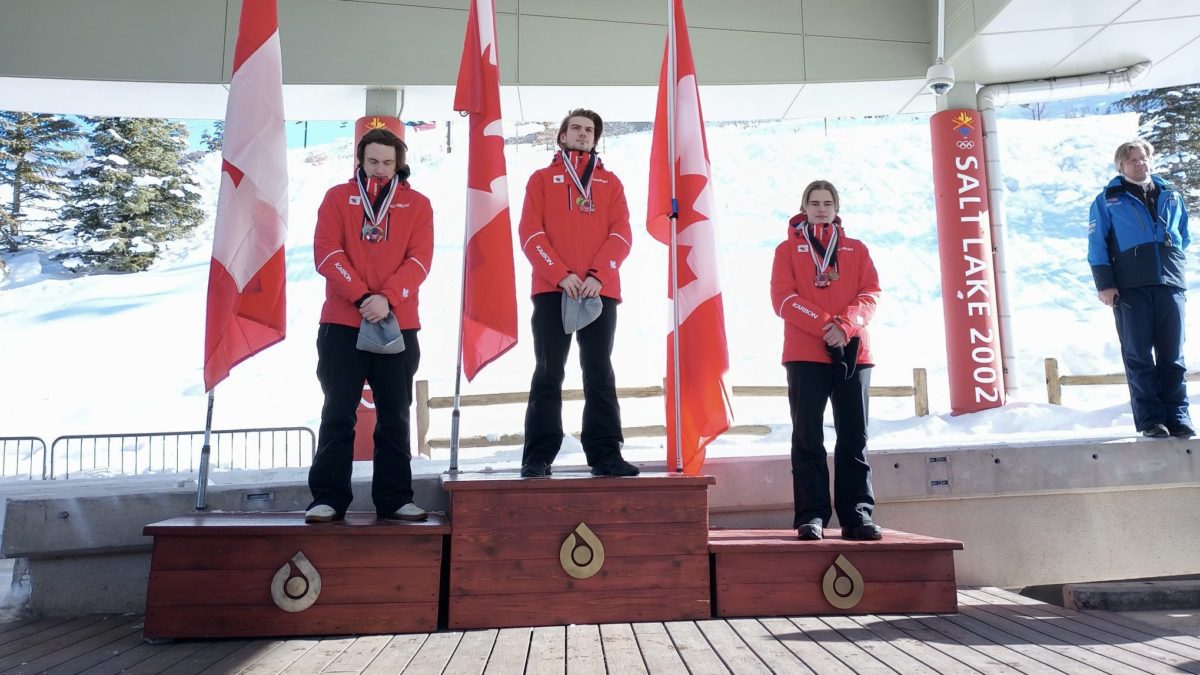 Canada sweeps multiple podiums at the Utah Olympic Park for a Continental Cup race on Saturday as Wasatch Luge Program Director, Race Technical Director, Podium Ceremony Announcer and Olympian Jon Owen looks on.