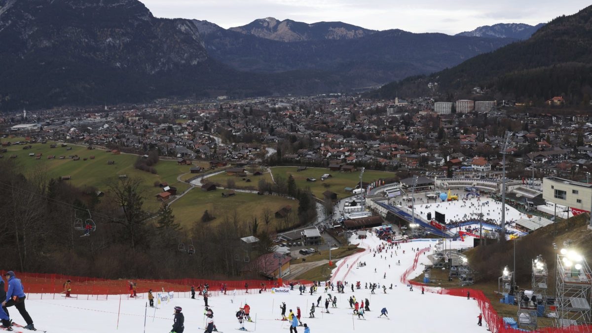 Athletes inspect the small strip of snow where they will compete in an alpine ski, men's World Cup slalom race, in Garmisch Partenkirchen, Germany, Wednesday, Jan. 4, 2023. Mother Nature and global warming are having just as much say about when and where to hold ski races these days as the International Ski Federation.
