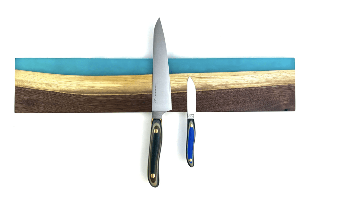 The White Rim resin knife magnet is crafted from walnut wood and aqua resin.