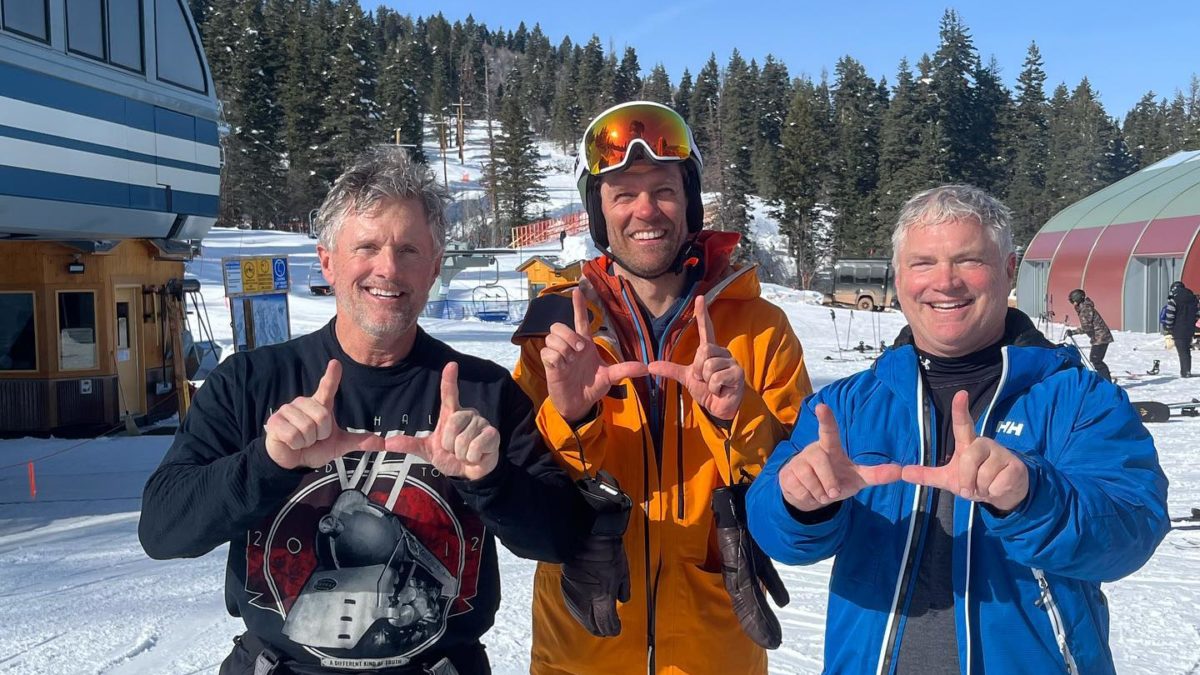 (L-R) University of Utah Football Coach Kyle Wittingham, US Ski Team racer Steven Nyman, and U of U Coach Freddie Wittingham skiing together in Utah in February and flashing the "U."