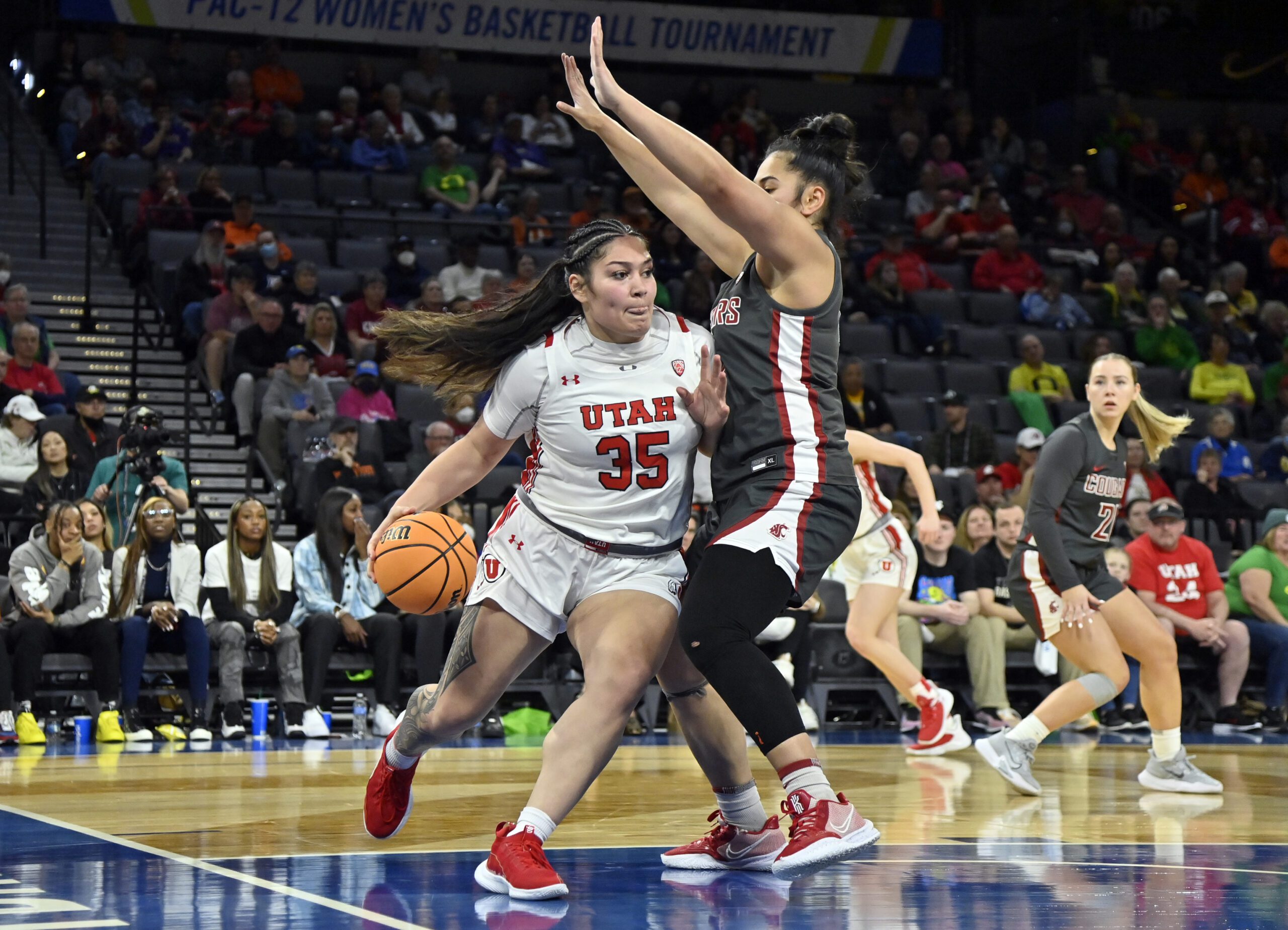 Utah forward Alissa Pili (35) drives against Washington State forward Ula Motuga during the second half of an NCAA college basketball game in the quarterfinals of the Pac-12 women's tournament Thursday, March 2, 2023, in Las Vegas.