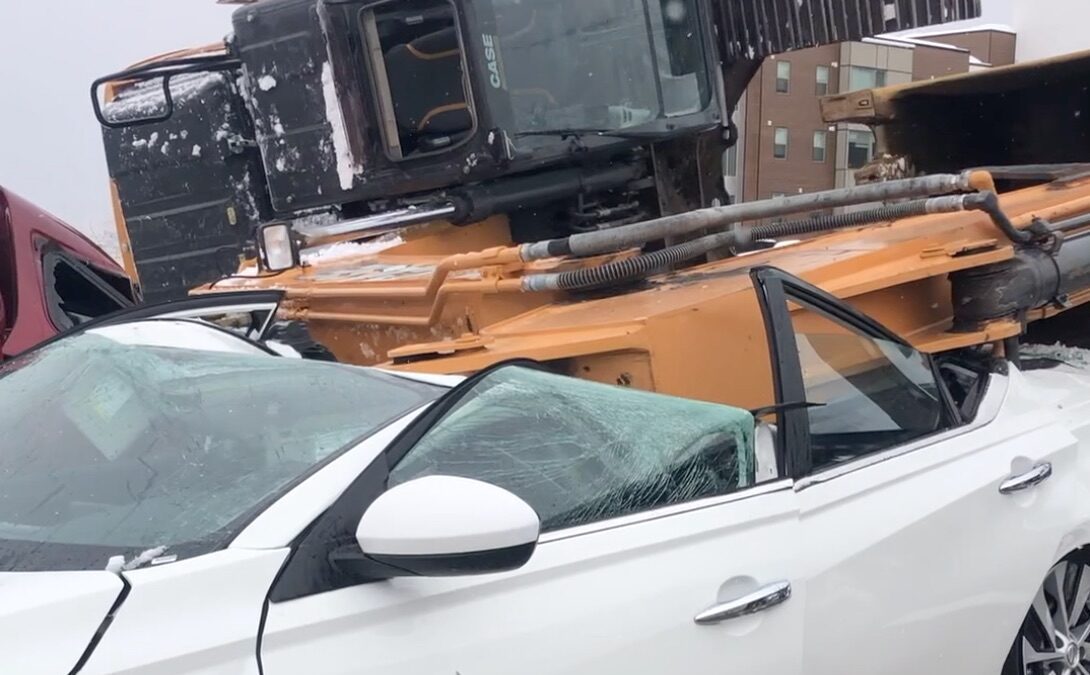 Excavator toppled over and crushed several vehicles in Canyons Village at Park City on March 30, 2023.