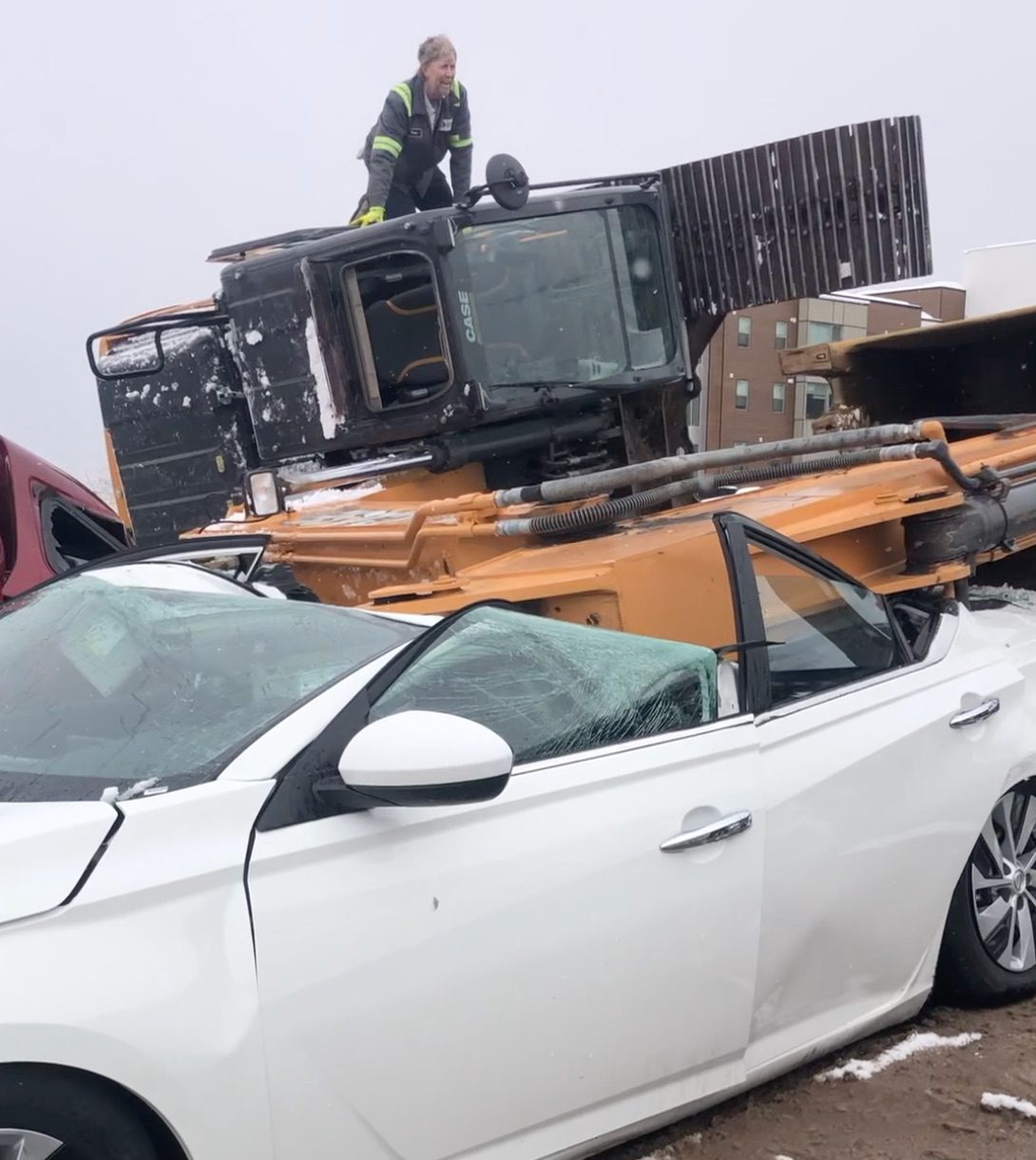 Excavator toppled over and crushed several vehicles in Canyons Village at Park City on March 30, 2023.