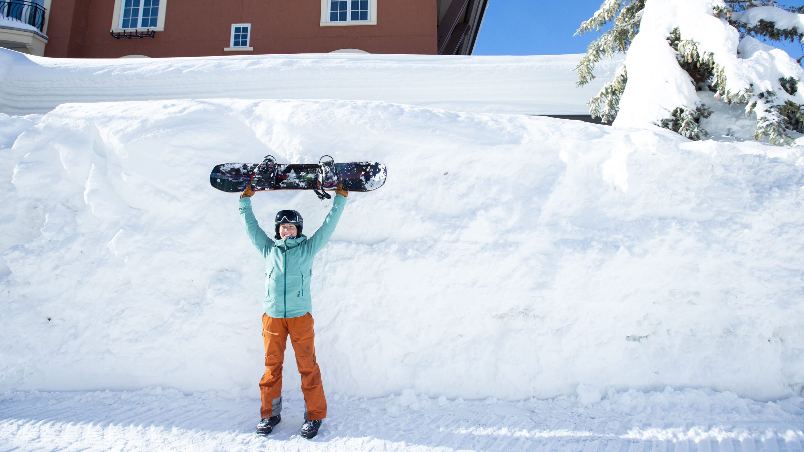 Athletes Sammy and Chelsea walk around Solitude village in the tall snowbanks.