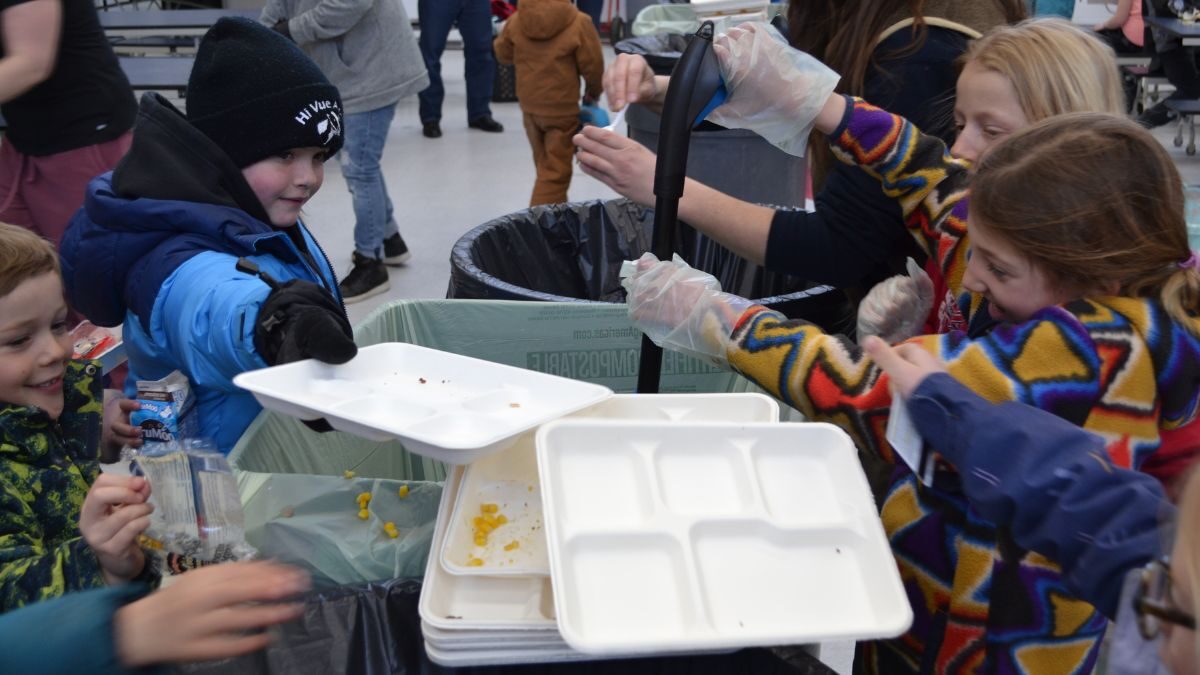 Students at Jeremy Ranch Elementary School sort the leftovers from their lunch trays as part of their school composting program.