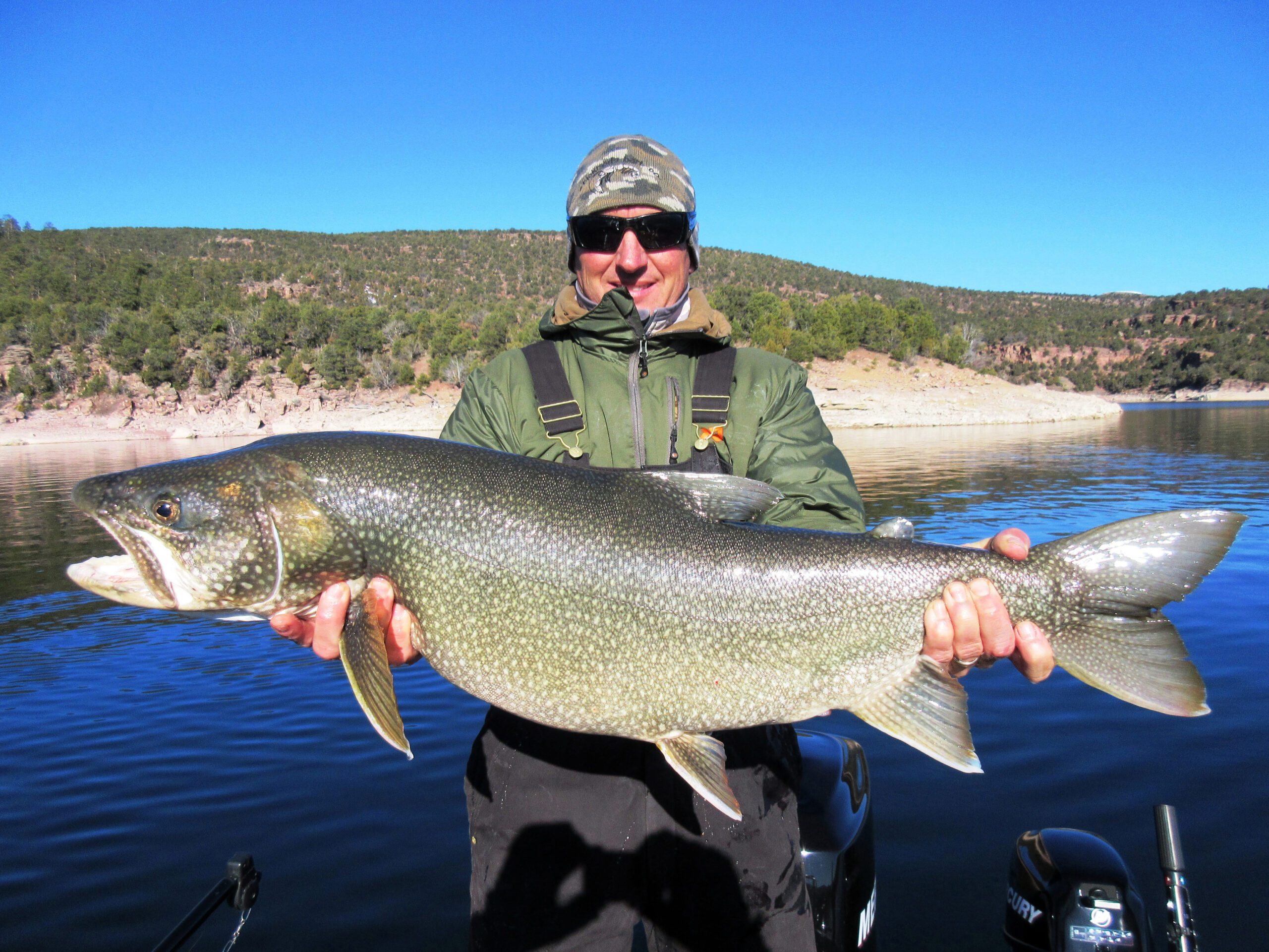 Ryan Mosley holding a trophy sized lake trout caught at Flaming Gorge.