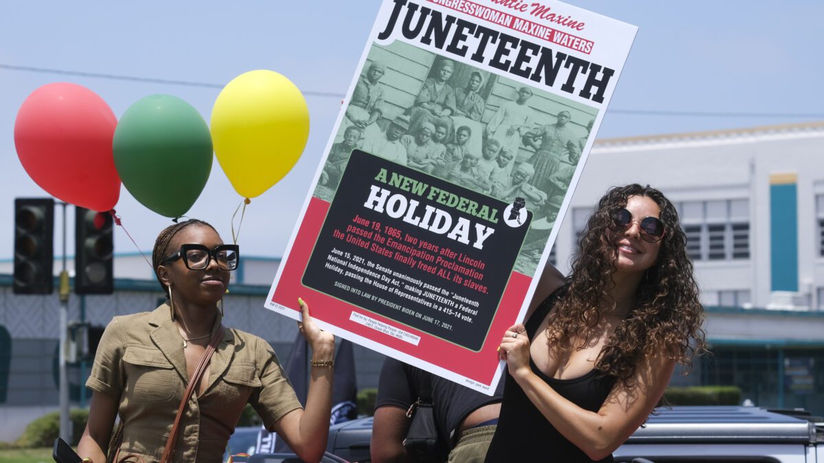 People hold a sign in their car during a car parade to mark Juneteenth on June 19, 2021, in Inglewood, Calif. Communities all over the country will be marking Juneteenth, the day that enslaved Black Americans learned they were free. For generations, the end of one of the darkest chapters in U.S. history has been recognized with joy in the form of parades, street festivals, musical performances or cookouts. Yet, the U.S. government was slow to embrace the occasion.