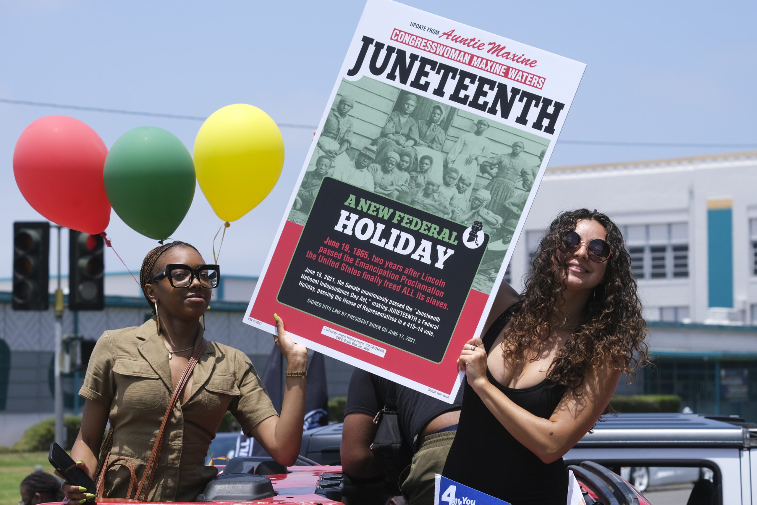 People hold a sign in their car during a car parade to mark Juneteenth on June 19, 2021, in Inglewood, Calif. Communities all over the country will be marking Juneteenth, the day that enslaved Black Americans learned they were free. For generations, the end of one of the darkest chapters in U.S. history has been recognized with joy in the form of parades, street festivals, musical performances or cookouts. Yet, the U.S. government was slow to embrace the occasion.