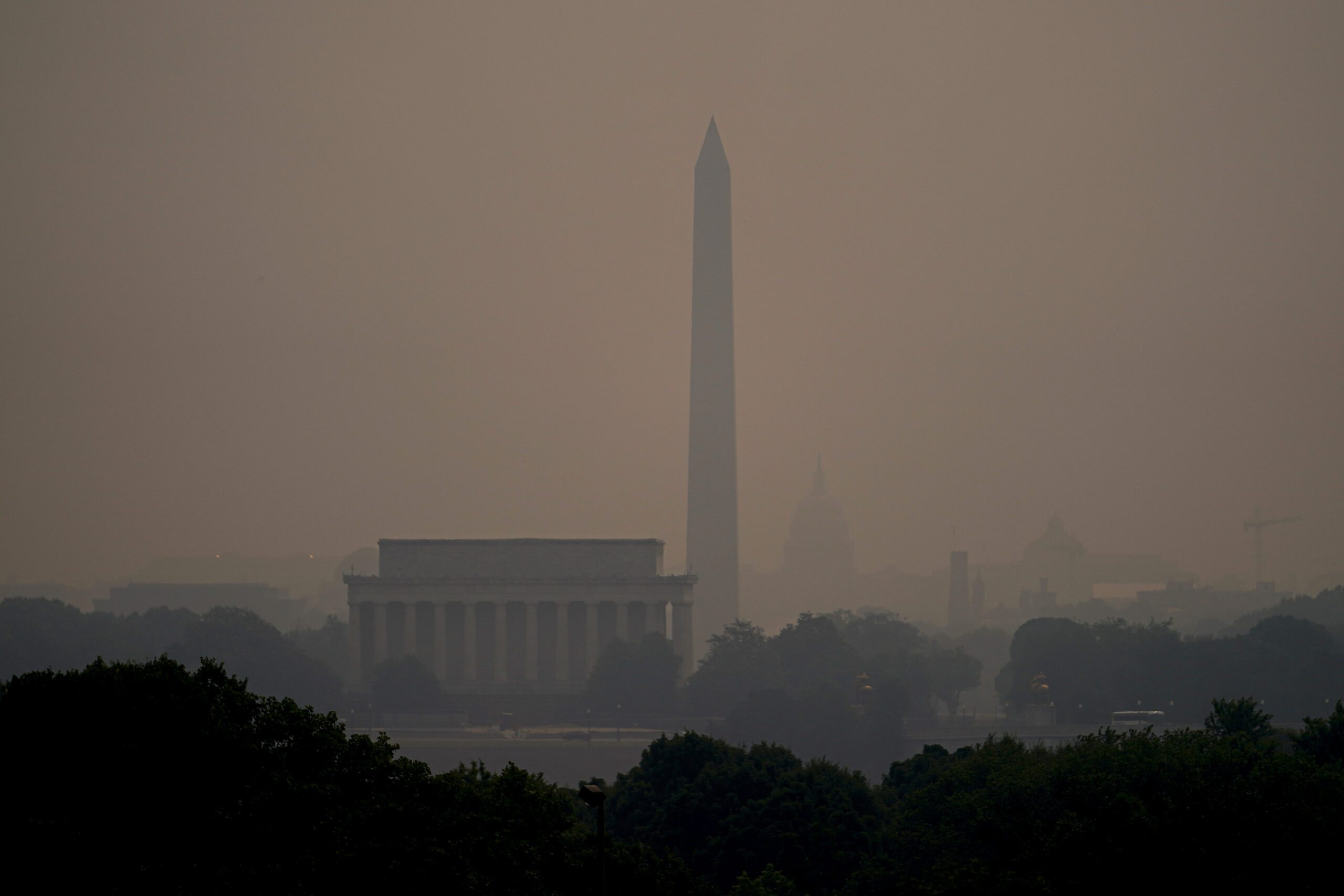 Haze blankets over monuments on the National Mall in Washington, Wednesday, June 7, 2023, as seen from Arlington, Va.