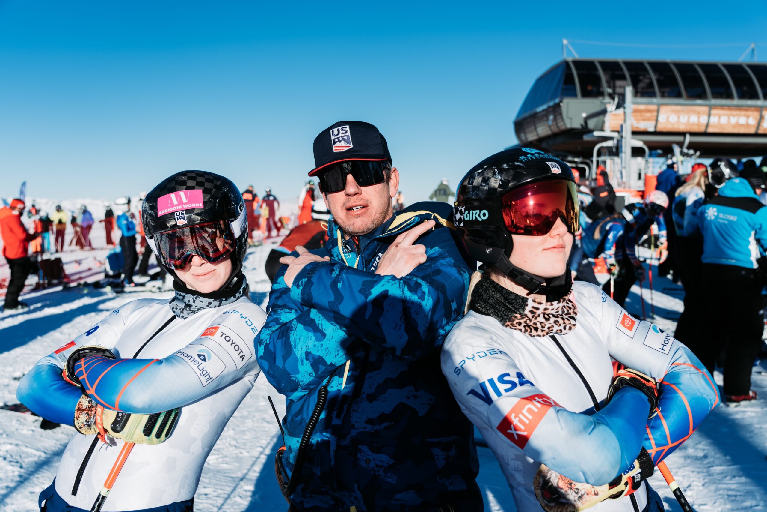 Bart Mollin, not taking himself too seriously after preparing the skis of the U.S. Ski and Snowboard alpine racers he's standing between.