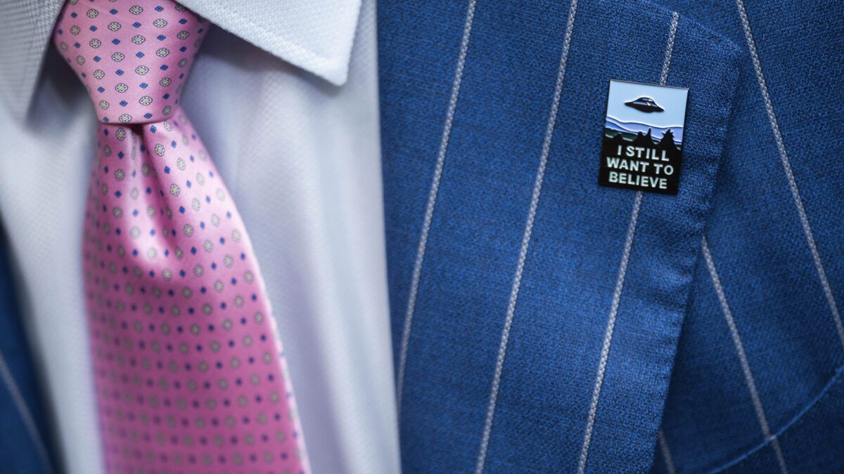 An audience member wears a UFO pin during a House Oversight and Accountability subcommittee hearing on UFOs, Wednesday, July 26, 2023, on Capitol Hill in Washington.