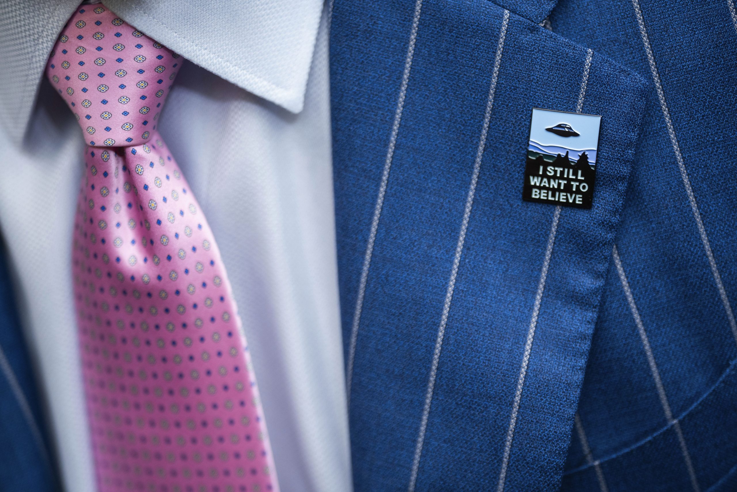 An audience member wears a UFO pin during a House Oversight and Accountability subcommittee hearing on UFOs, Wednesday, July 26, 2023, on Capitol Hill in Washington.