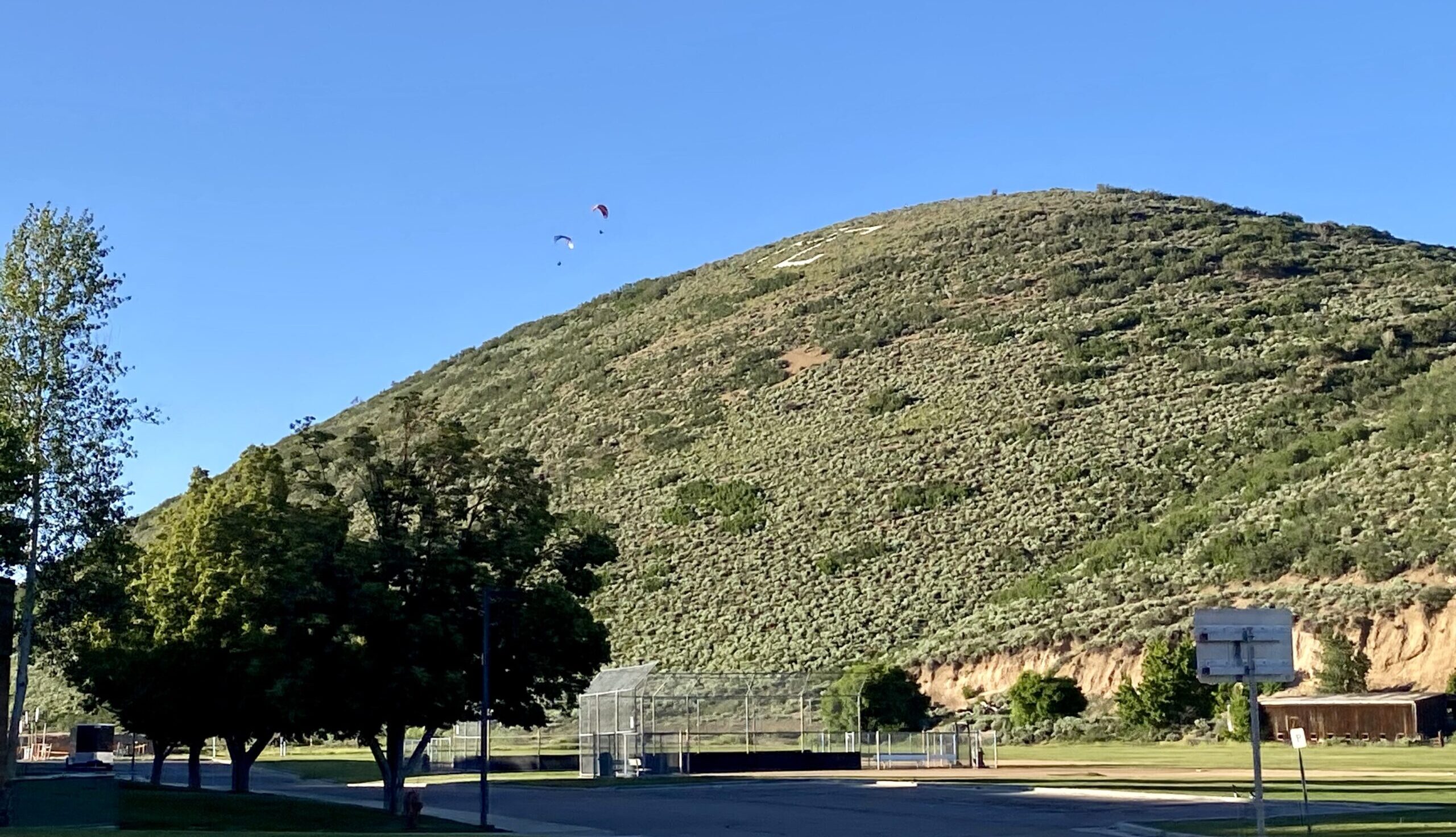 A pair of paragliders playing above the park at Park City Hill, July 14, 2023.