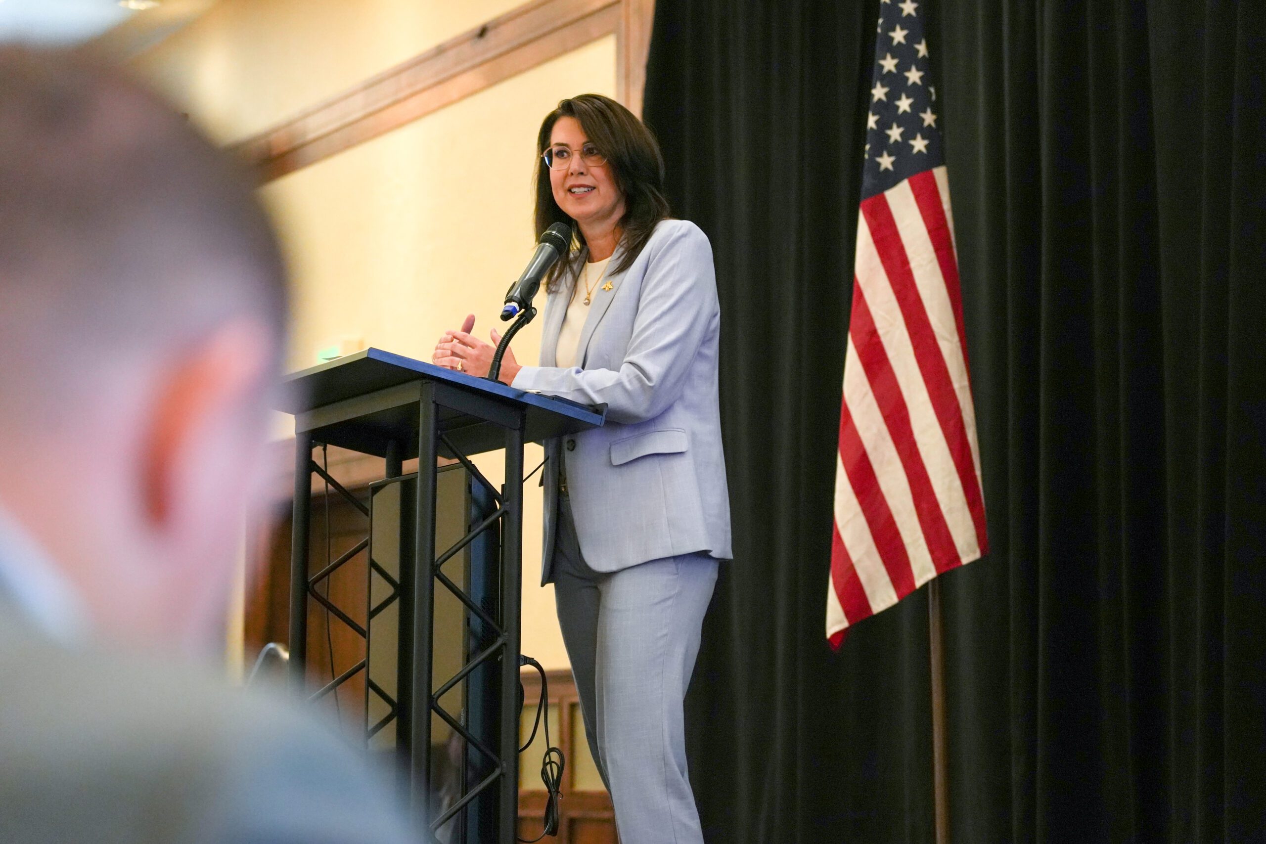 Lieutenant Governor Deidre Henderson delivering a speech at the Tri-State Telecommunications Conference.