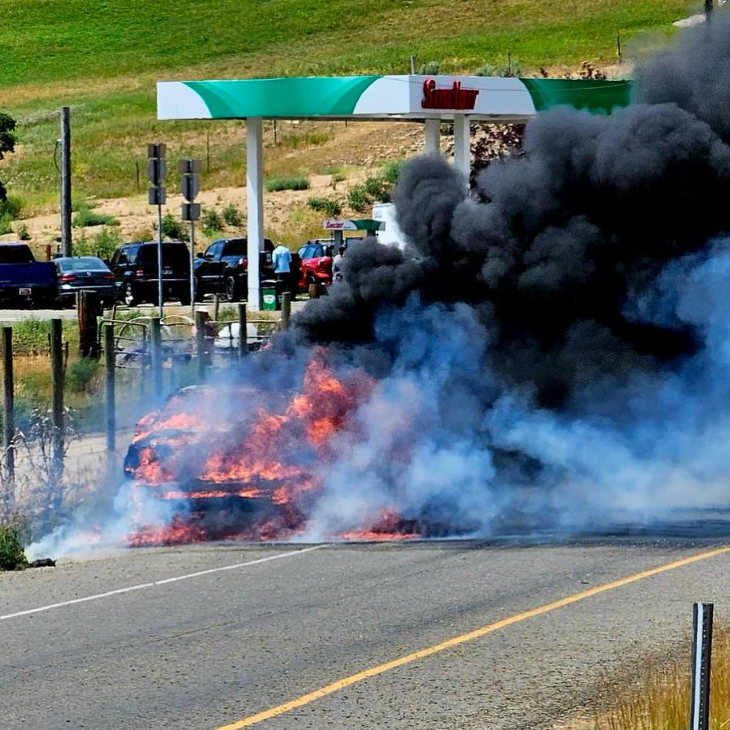 Trailer fully engulfed in flames and the fire spreading to the nearby grass on I-80 at mile marker 155.