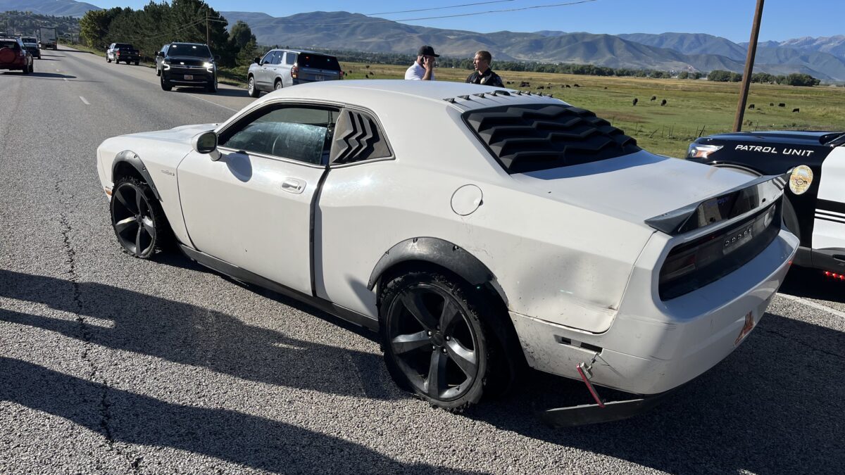 Stolen Dodge Challenger after police successfully deployed spike strips, puncturing the vehicle’s driver-side tires.