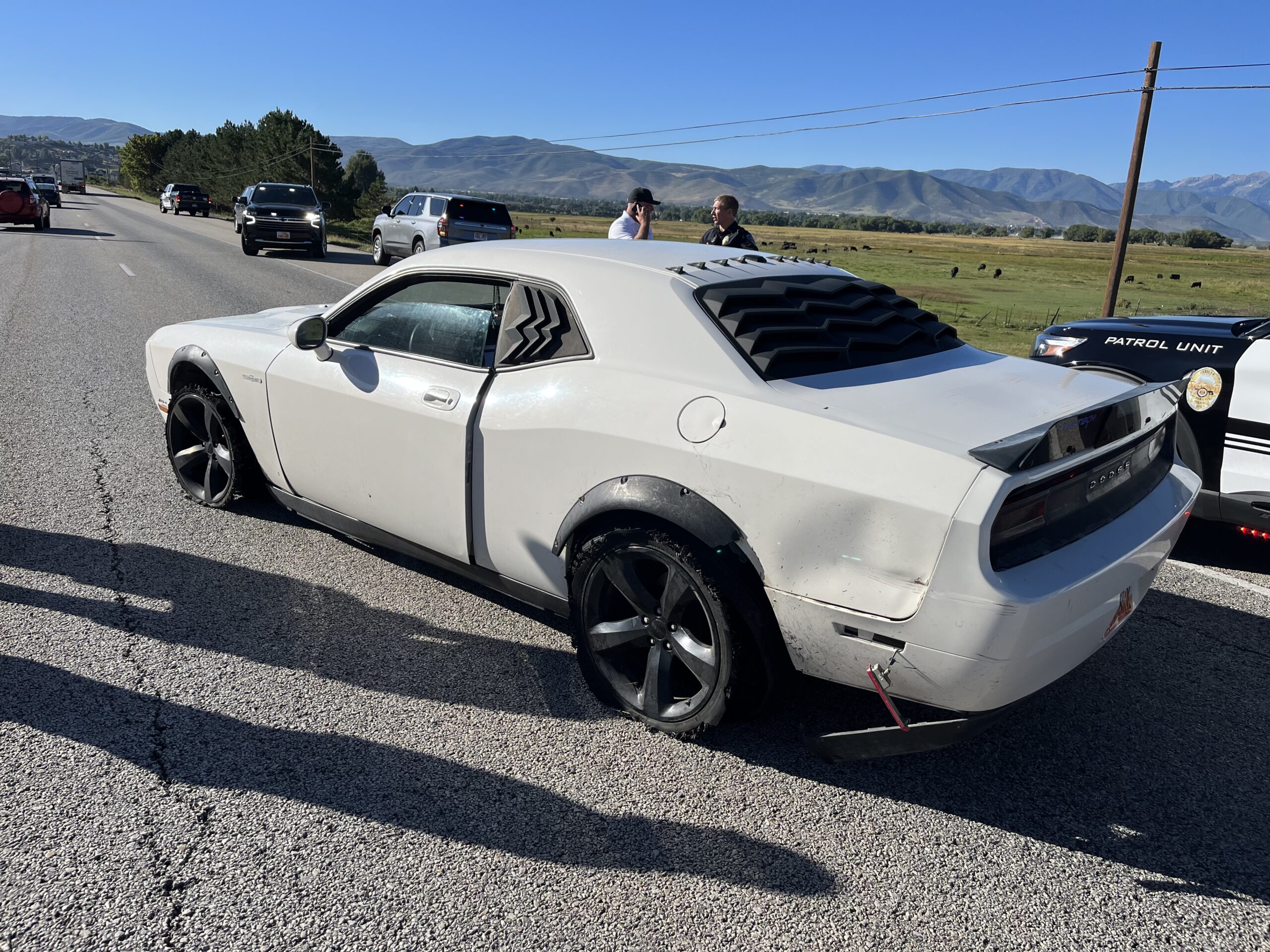 Stolen Dodge Challenger after police successfully deployed spike strips, puncturing the vehicle’s driver-side tires.