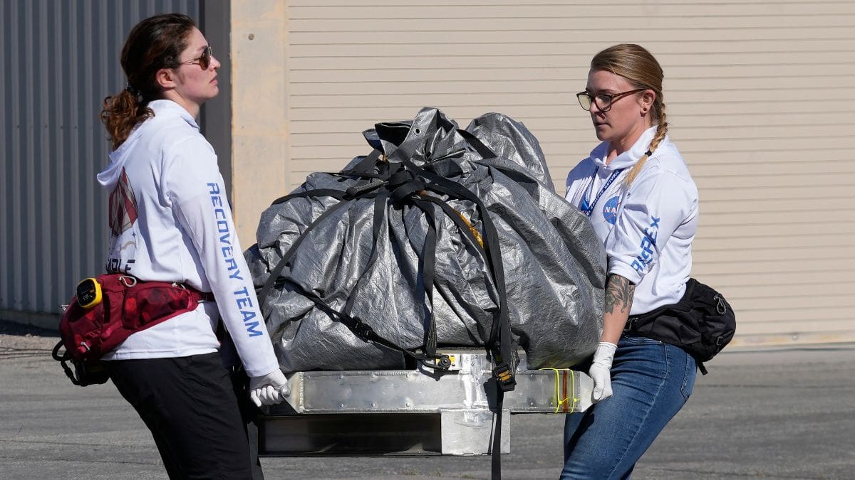 Recovery team members carry a capsule containing NASA's first asteroid samples to a temporary clean room at Dugway Proving Ground in Utah on Sunday, Sept. 24, 2023. The Osiris-Rex spacecraft released the capsule following a seven-year journey to asteroid Bennu and back.