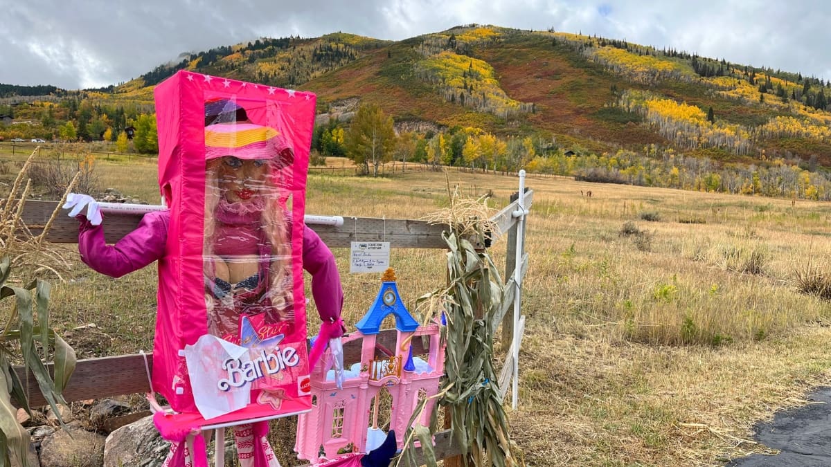 A Barbie™ themed scarecrow pops against the fall foliage at the annual Scarecrow Festival at McPolin Barn.