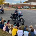 The Park City Police motorcycle officers give a lights and sirens show for some McPolin Elementary students.