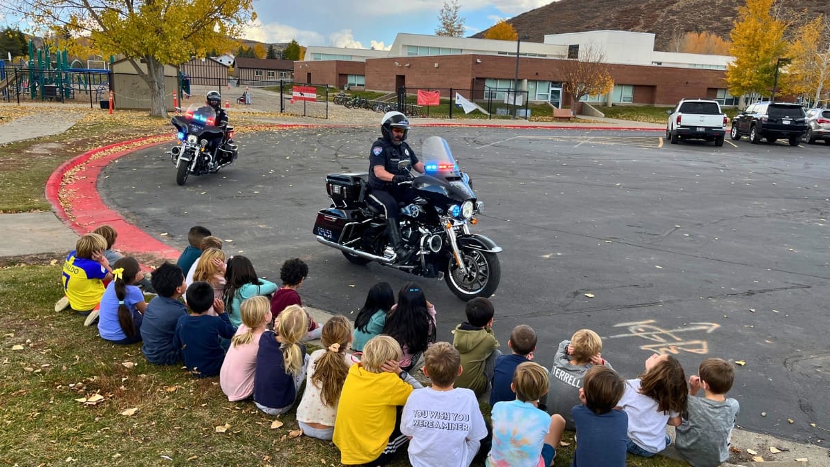 The Park City Police motorcycle officers give a lights and sirens show for some McPolin Elementary students.