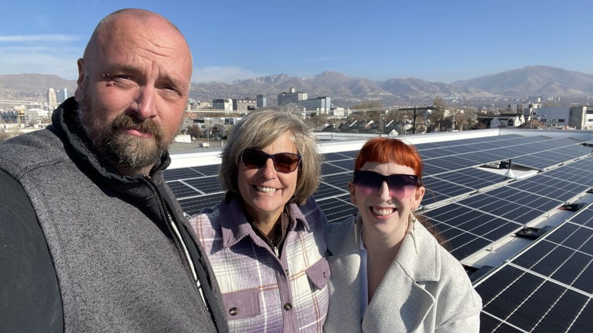 Executive Director, Park City's Donna Matturro McAleer standing in between Steve Welch, R&O Construction Superintendent, and Ashley Iordanov, Principal Architect, Atlas Architects at the 141 solar panels on the new Bicycle Collective building in Salt Lake City.