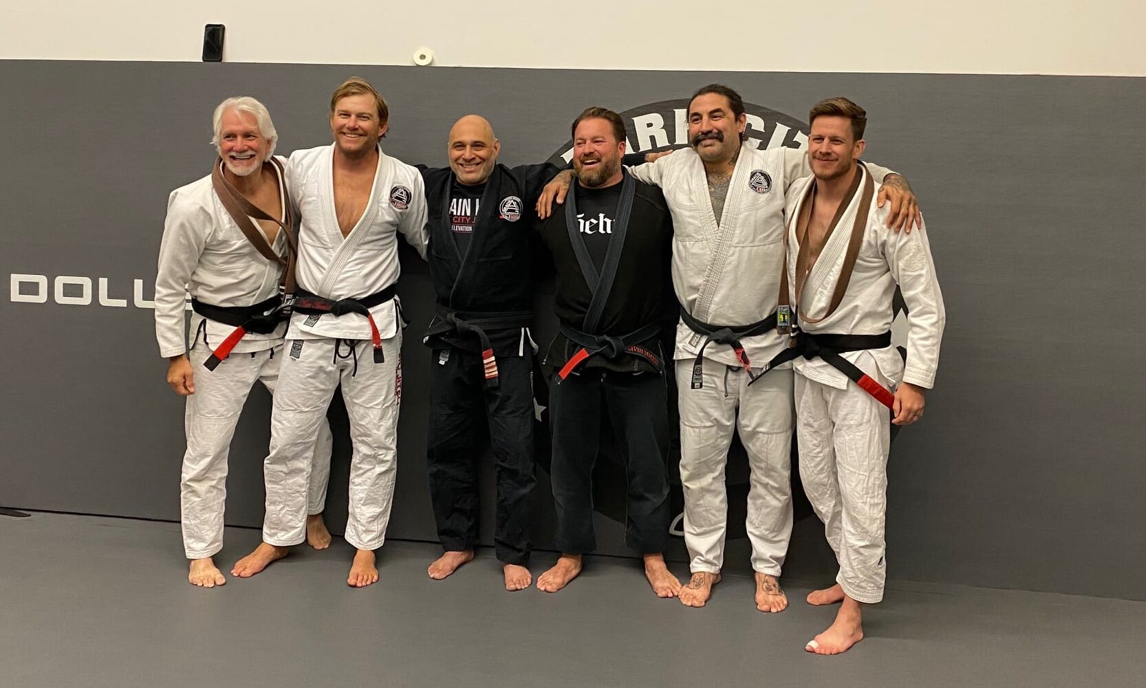 Black belt recipients Chris Wilson (far right) and Keith Barnhart (far left) from Mike Diaz (3rd in from the left) who is the owner at Park City Jiu Jitsu.