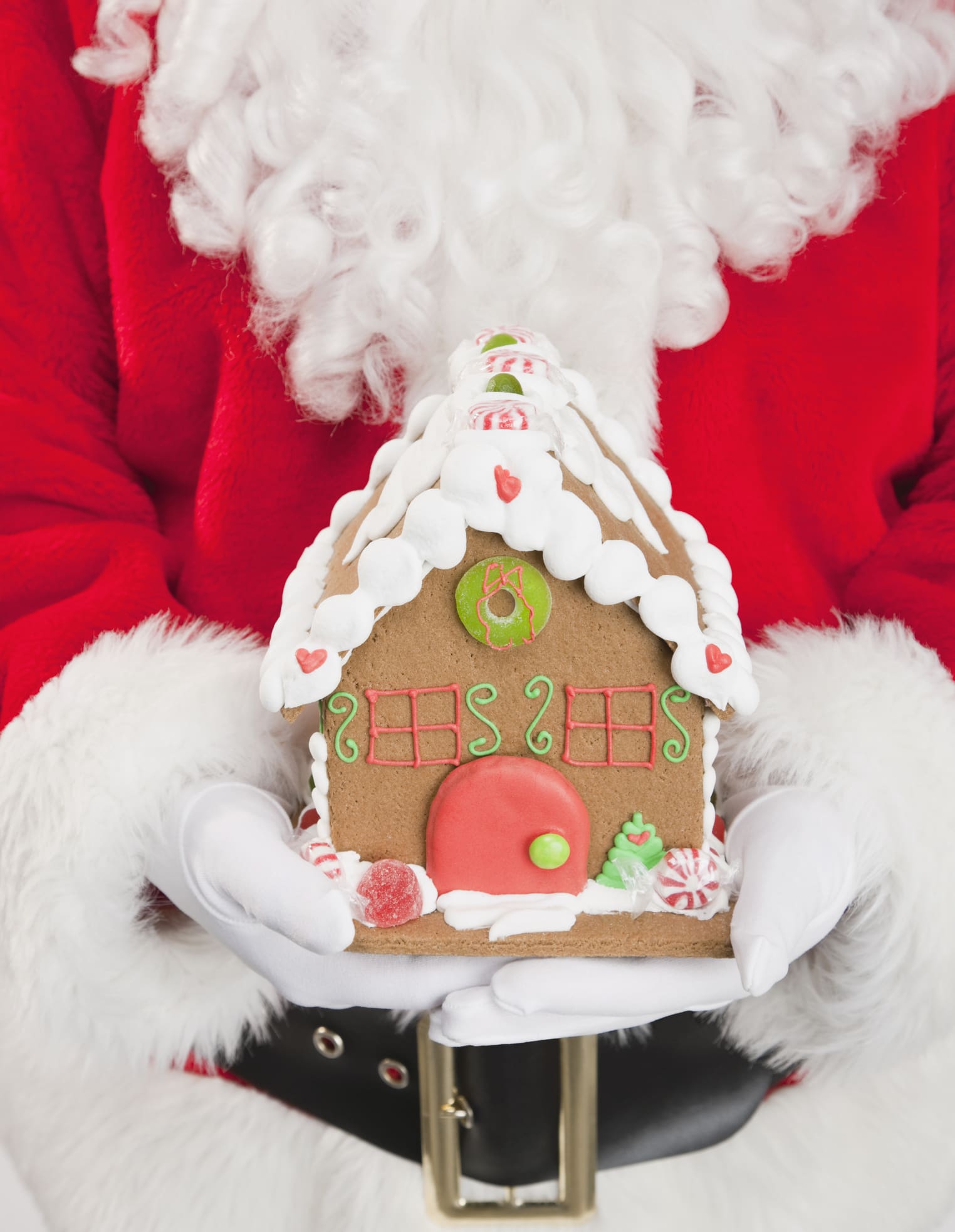 Santa Claus holding a gingerbread house