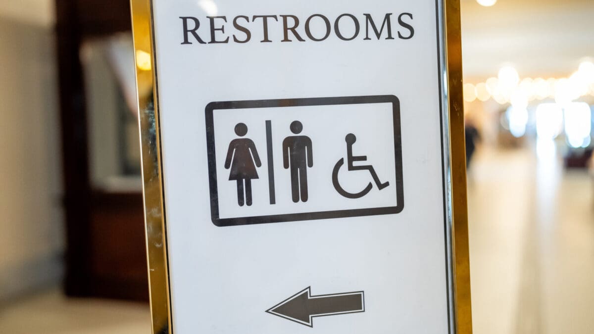 A sign points to bathrooms at the Capitol in Salt Lake City.