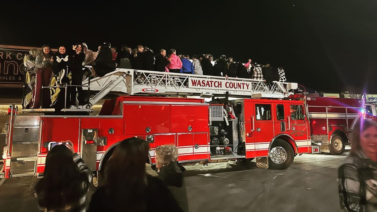 The Wasatch High School Cheer team celebrates its 5A co-ed State Championship win with a celebratory ride on the Wasatch Fire truck on Saturday, Jan. 27.
