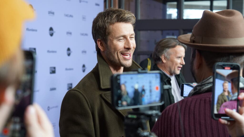 Austin, Texas native and Top Gun actor, Glen Powell with Richard Linklater in the background, before the world premiere of Hit Man. A movie that the duo developed together.