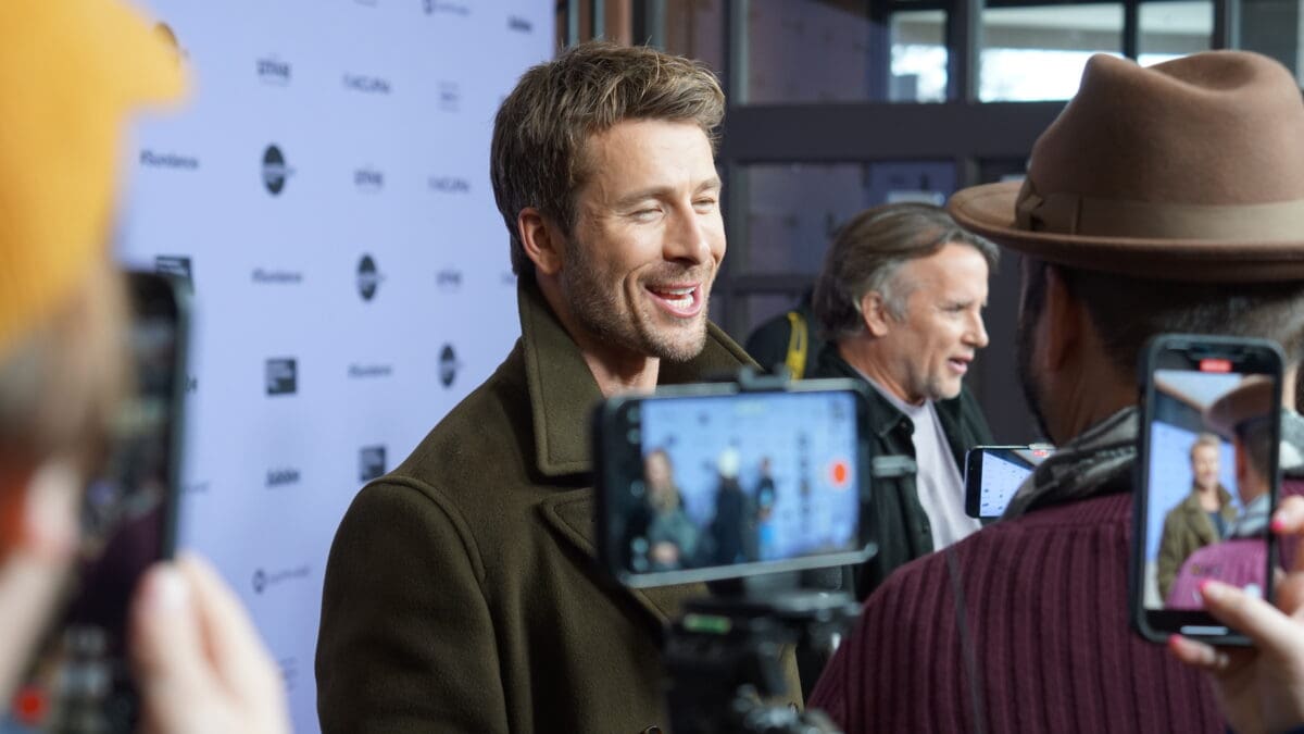 Austin, Texas native and Top Gun actor, Glen Powell with Richard Linklater in the background, before the world premiere of Hit Man. A movie that the duo developed together.