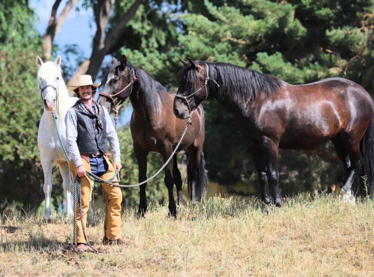 Jake with the three mustangs who are accompanying him on his cross country journey.