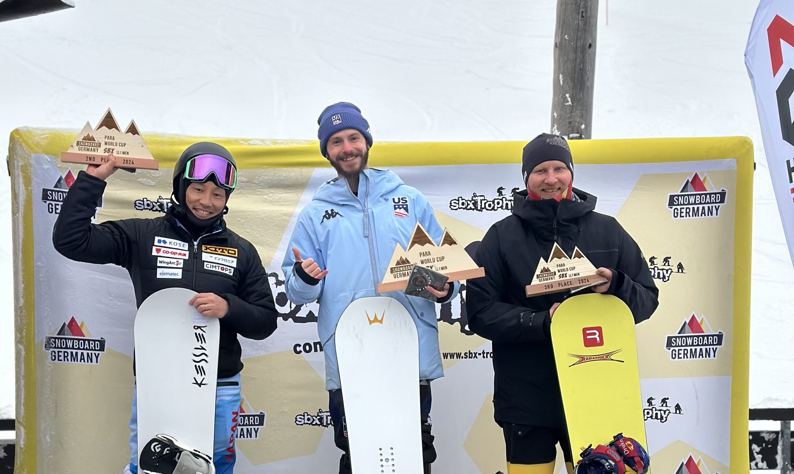 Noah Elliott of the U.S. Para Snowboarding Team stands atop the podium in Germany, following his back-to-back snowboard cross wins. Not pictured, Brenna Huckaby, Kate Delson, or Keith Gabel on the podium at the same competition.