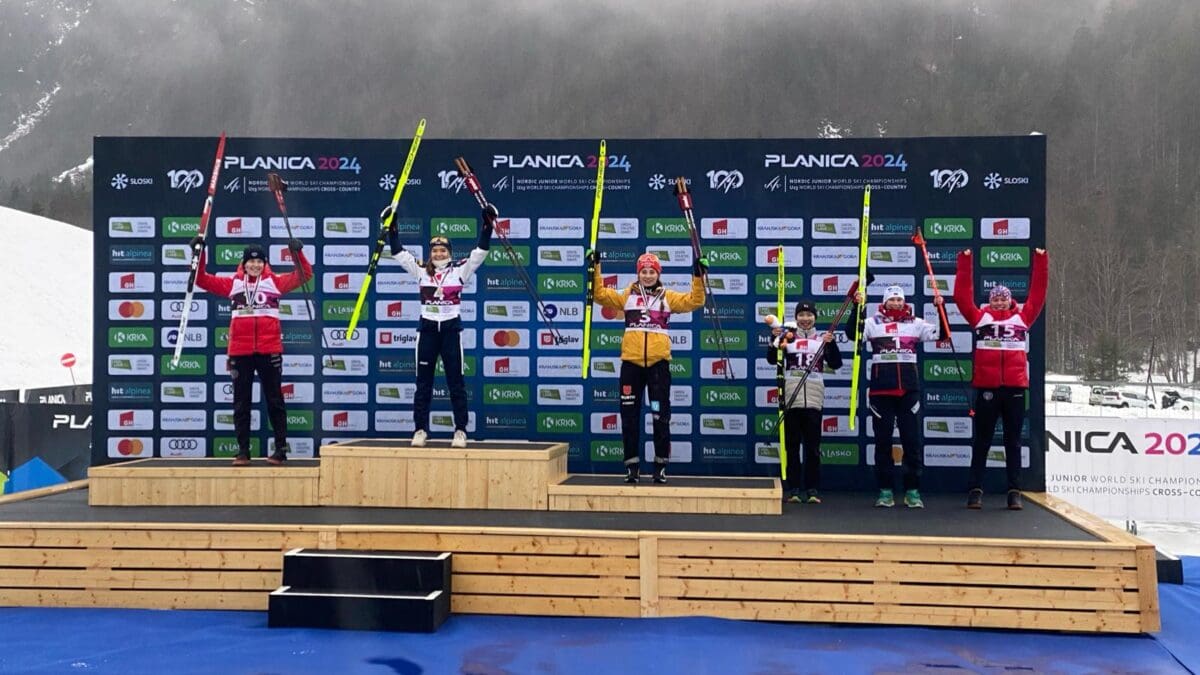 USA's Alexa Brabec (far left) getting her silver medal at FIS Nordic Jr. World Ski Championships in Planica, Slovenia for Women's Nordic Combined. Teammate Kai McKinnon (far right) places 6th.