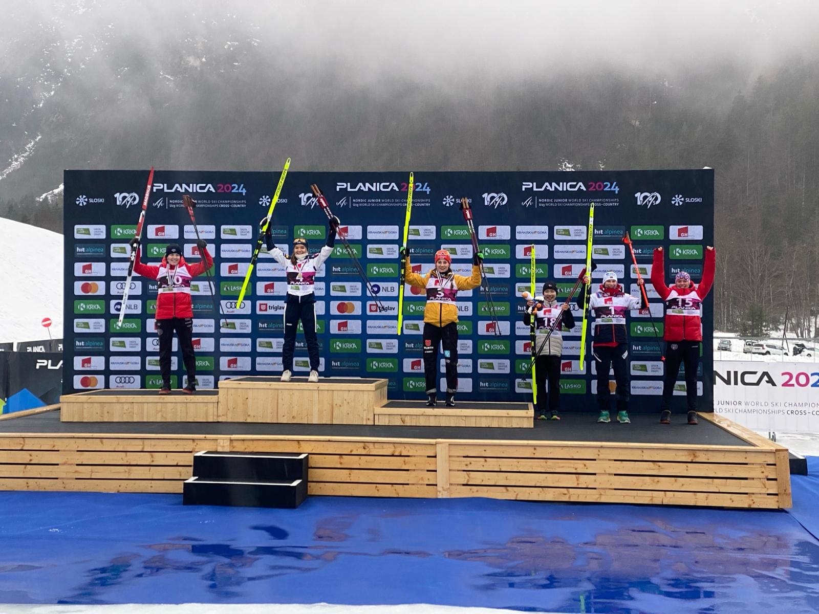 USA's Alexa Brabec (far left) getting her silver medal at FIS Nordic Jr. World Ski Championships in Planica, Slovenia for Women's Nordic Combined. Teammate Kai McKinnon (far right) places 6th.