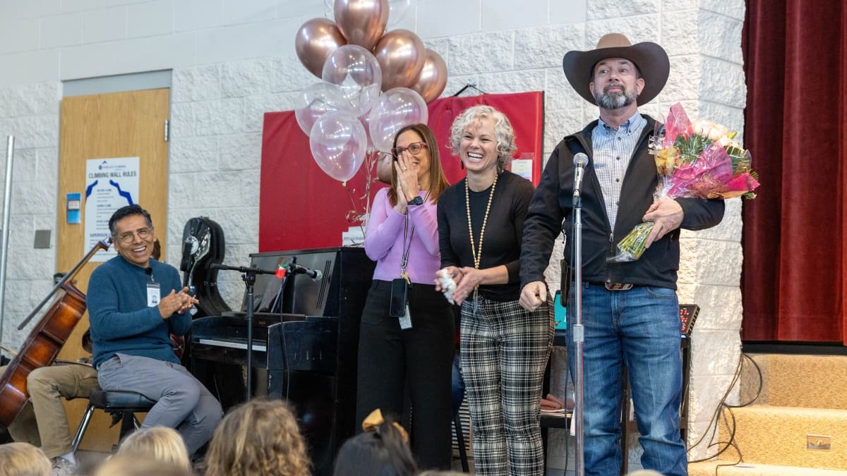 Jennifer Bramson celebrates her award at a surprise party at McPolin Elementary on March 25. From left to right, Principal Angie Dufner, Jen Bramson and Mike Evans (President USEA.